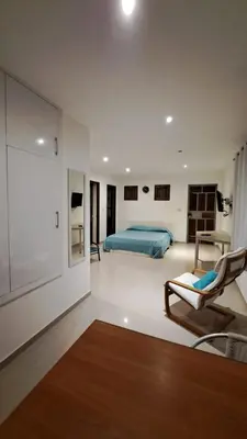 a bedroom with a bed and a couch and a chair at Studio Cruz Espia in Mindelo