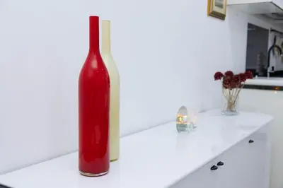 a red bottle sitting on a counter in a kitchen at Casa kretcheu Mindelo in Mindelo
