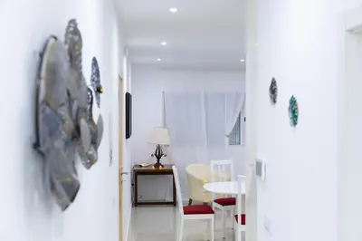 a white room with a table and chairs and a door at Casa kretcheu Mindelo in Mindelo