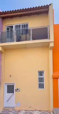 a yellow house with a balcony on top of it at Casa kretcheu Mindelo in Mindelo