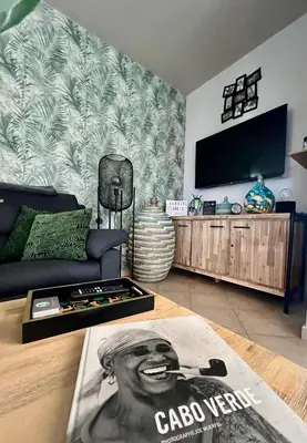 a living room with a couch and a flat screen tv at Tropical Manera in Santa Maria