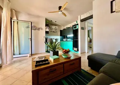 a living room with a couch and a table at Tropical Manera in Santa Maria