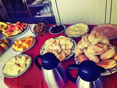 a table full of different types of food on plates at Residencial Cosmos in Assomada