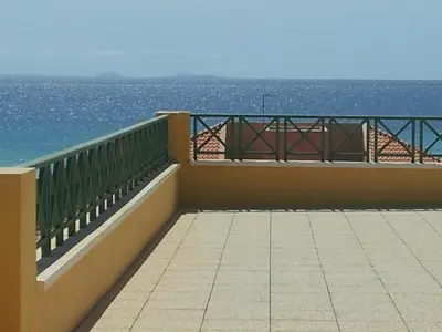 a balcony with a view of the ocean at Holiday Properties Commercial Center - Wi-fi in Santa Maria
