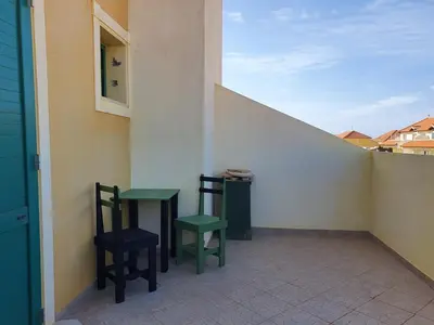 two chairs and a table on a balcony at Holiday Properties Commercial Center - Wi-fi in Santa Maria