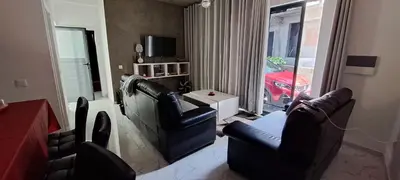 a living room with two chairs and a red car at Liminha Guest House in Calheta de São Miguel