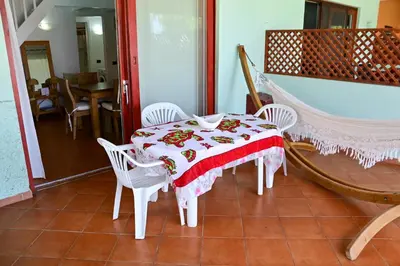 a table and chairs with a red and white table cloth at Porto Antigo II Poolside Appartment in Santa Maria