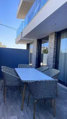 a blue table and chairs in a building at Condomínio Horizonte in Praia