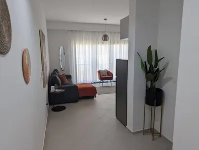a living room with a couch and a chair in a room at Tarrafal Bay - 1Bdr Apt - Sea view - 4 in Tarrafal