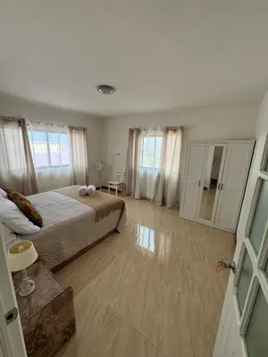 a large bedroom with a bed and a bathroom at Casa Carveiros Panoramic 360 in Tarrafal