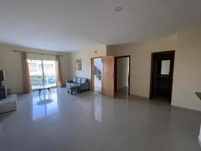 an empty living room with a couch and a chair at Suites Home Tarrafal in Tarrafal