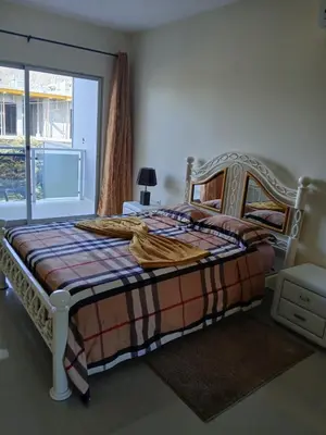 a bedroom with a bed with a blanket on it at Suites Home Tarrafal in Tarrafal