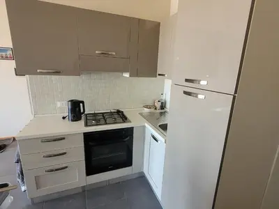 a small kitchen with a stove and a refrigerator at Blu Jasmine in Sal Rei