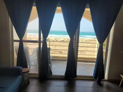 a living room with a view of the ocean from a window at Blu Jasmine in Sal Rei