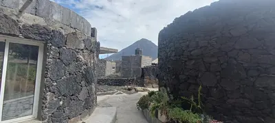 a stone wall with a view of a mountain at Casa Mamã in Portela