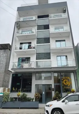 a white car parked in front of a tall building at Peace of mind in Praia