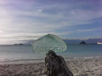 a glass object on a beach with the ocean at Hotel Lazareto in Mindelo