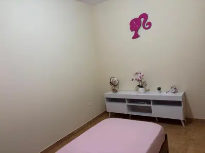 a white room with a bed and a dresser at Techas Family Beach Stay 3BR in Central Tarrafal in Tarrafal