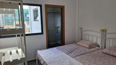 a bedroom with a bed and a large mirror at Casa Maré & Museu - Porta Nº 18 in Mindelo