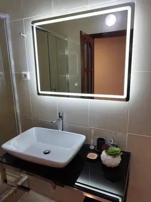 a bathroom with a white sink and a mirror at Apartamento T1, amplo e arrejado in Praia