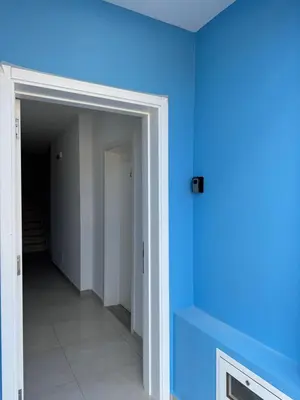 a hallway with a blue wall and a door at Apartment Boadventure in Sal Rei