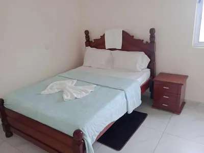 a bedroom with a bed with a towel on it at Magei in Tarrafal