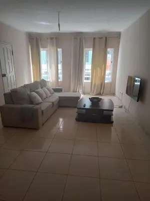a living room with a couch and a tv at Morabeza Praia in Praia