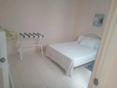 a small bedroom with a bed and a table at Morabeza Praia in Praia