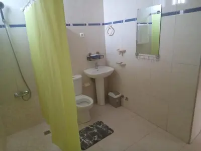 a bathroom with a toilet and a sink and a mirror at Morabeza Praia in Praia