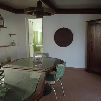 a dining room with a glass table and chairs at Ca Azul in Tarrafal