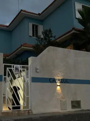 a door to a house with a sign on it at Ca Azul in Tarrafal
