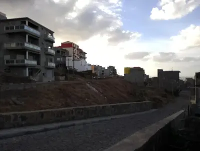 a road with buildings on the side of a hill at ApartamentoT1 Ponta do Sol in Ponta do Sol