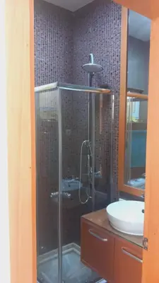 a bathroom with a shower and a sink at Relache House Praia in Praia