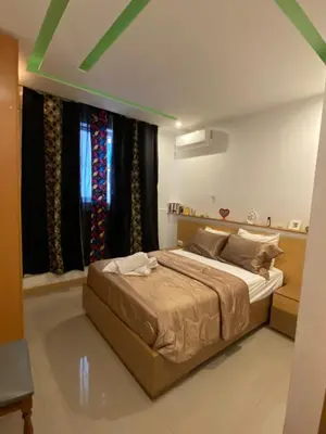 a bedroom with a large bed in front of a window at Infinito house in Praia