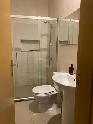 a bathroom with a shower and a toilet and a sink at Infinito house in Praia
