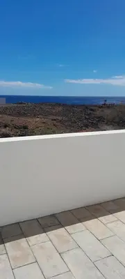 a white bench with the ocean in the background at Cacimba Sunset Lodge in Tarrafal