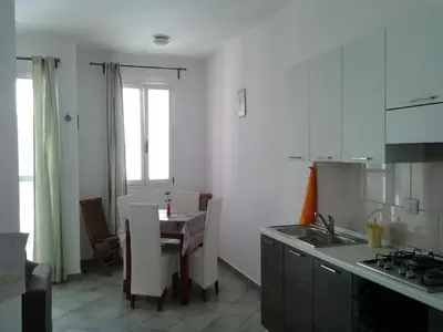 a kitchen with a table and a dining room at Casa Sara Boavista in Sal Rei
