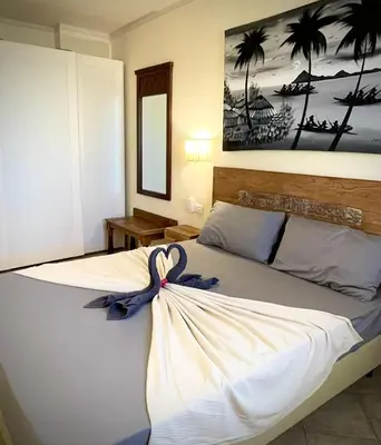 a bedroom with a bed with a blue bow on it at Ocean & Pool - 2 bedroom Apartment in Santa Maria
