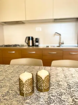 a kitchen with a table with a counter top at Ocean & Pool - 2 bedroom Apartment in Santa Maria