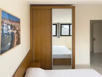 a bedroom with a mirror and a bed in it at 1 bdr cozy central apt in Praça Center - LCGR in Praia