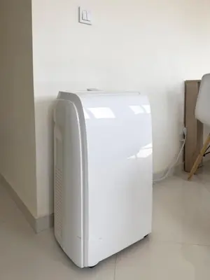 a white refrigerator sitting on the floor in a room at 1 bdr cozy central apt in Praça Center - LCGR in Praia