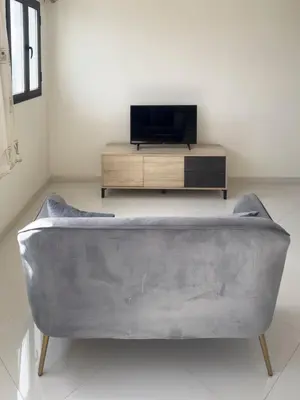 a living room with a couch and a tv at 1 bdr cozy central apt in Praça Center - LCGR in Praia