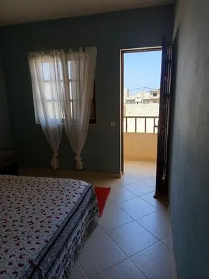 a bedroom with a bed and a large window at Appartamento Gianni in Santa Maria