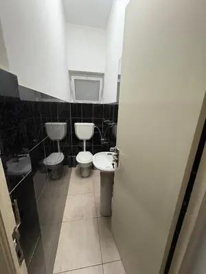 a bathroom with two toilets and a sink at Prainha Beach House in Praia
