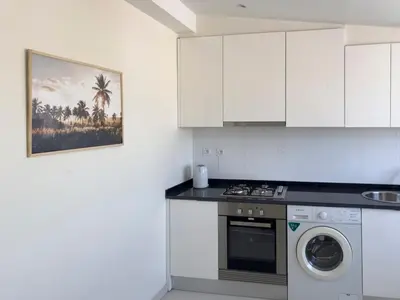 a kitchen with a stove and a washing machine at 2 bdr charming central apt in Praça Center - LCGR in Praia