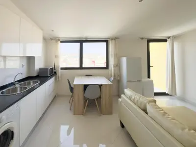 a kitchen with a couch and a table and a refrigerator at 2 bdr charming central apt in Praça Center - LCGR in Praia
