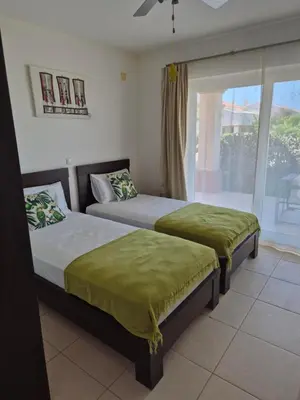 two beds in a room with a window at 3 Bedroom property in Paradise Beach in Santa Maria