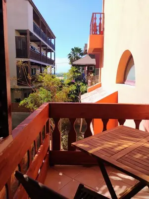 a wooden balcony with a wooden table and a view at Greta Apartment in Santa Maria