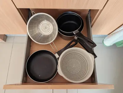 four different pots and pans in a drawer at SeafrontView - Cozy T1 Apartment 1 in Praia