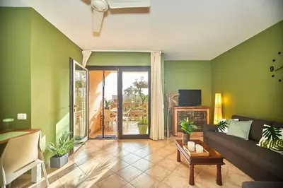 a living room with green walls and a couch at Tropical Casa Verde Santa Maria G01 in Santa Maria